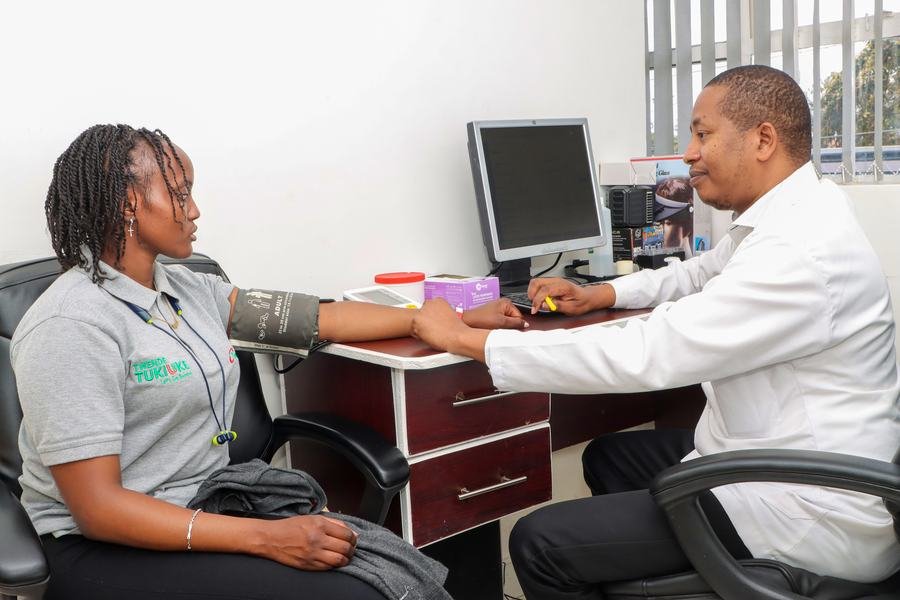 Doctor checking a patient's blood pressure during a general consultation